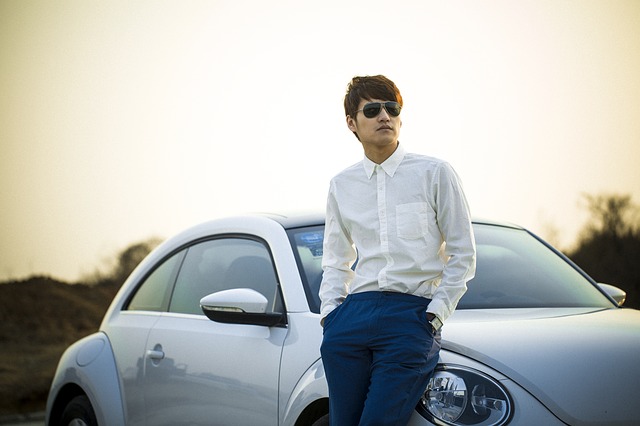 Man standing next to his car contemplating the psychopathology of males