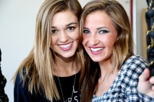 Two young female roommates smiling