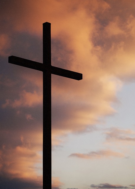 Cross seen through a cloudy sky