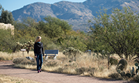 Sierra Tucson and woman walking on trail