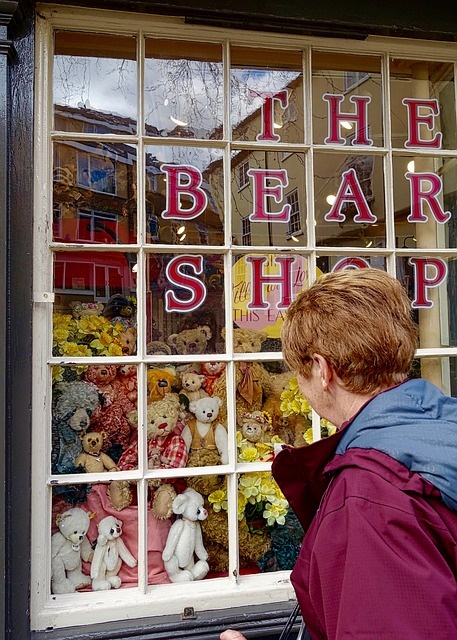 Woman looking in a store window while shopping