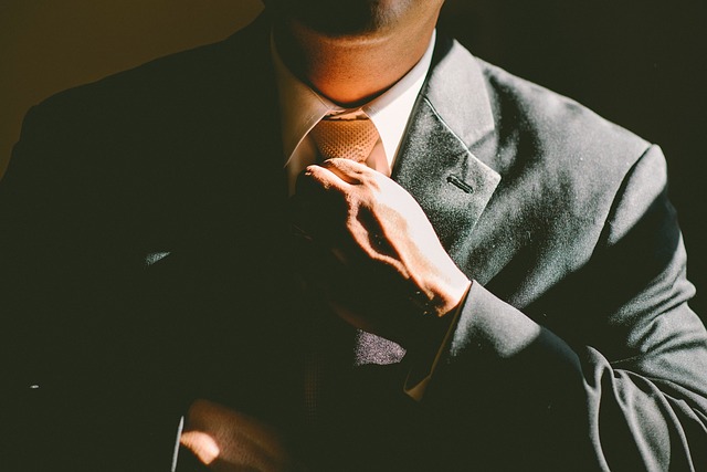 Man adjusting his tie and increasing his Self-worth