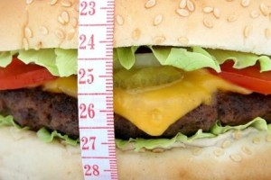 Large Cheeseburger being measured.