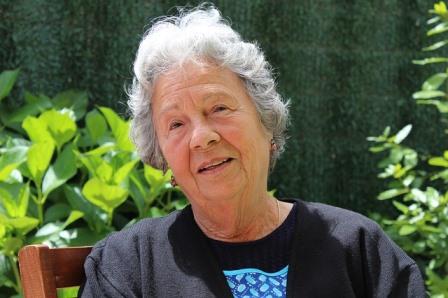 Elderly woman sitting.