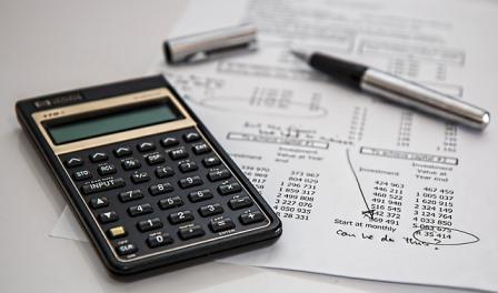 Student loan spreadsheet and calculator on a desk