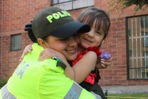 Police officer hugging young girl