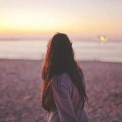 Woman on beach suffering from the Recurrence of Anorexia