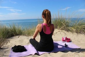 Woman doing yoga at the beach