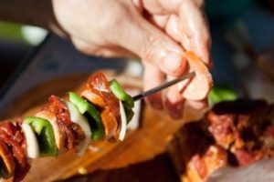 Woman preparing a bbq kabob for dinner