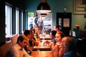 Family sitting down to dinner at a resturant