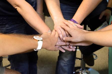 Treatment team with hands together