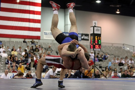 Wrestler slamming his opponent