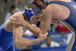 Two men wrestling after whistle