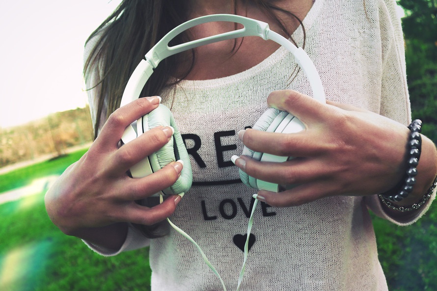 College student holding headphones