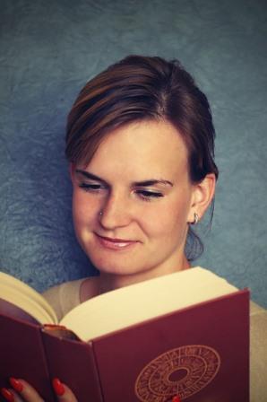 College student reading a thick book
