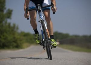 Cyclist coasting on her bike