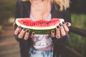 Woman eating watermelon and trying to Understand Orthorexia