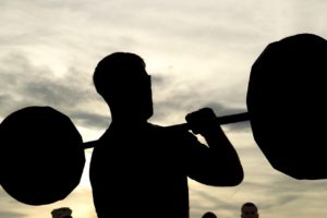 Man muscles lifting weights