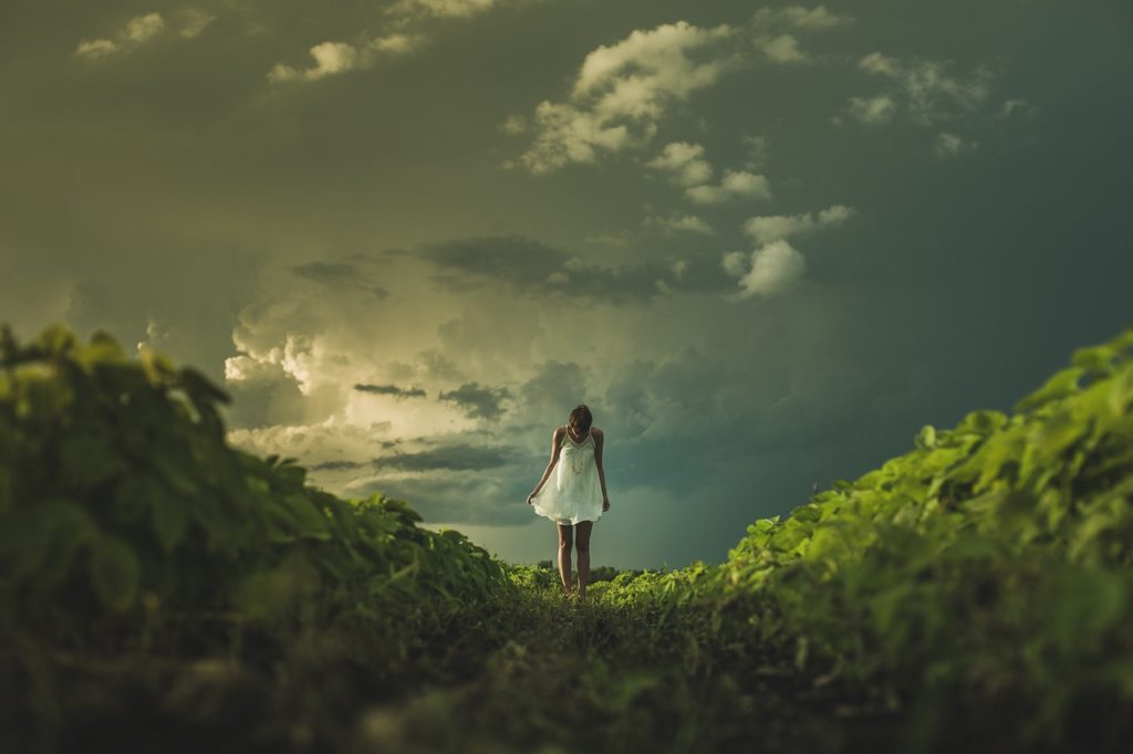 teenager relapsing into Bulimia and standing on a hill