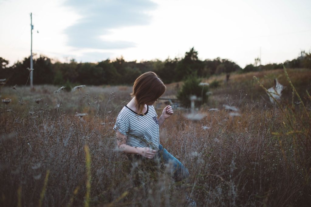 Woman with eating disorder in field