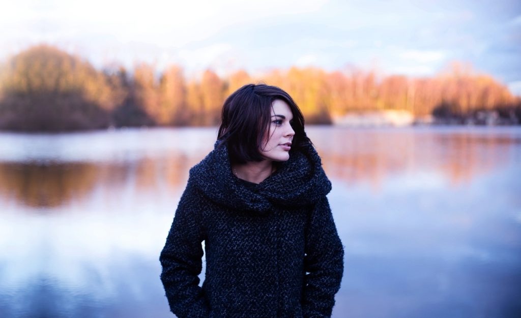 Woman Walking Along The Lake