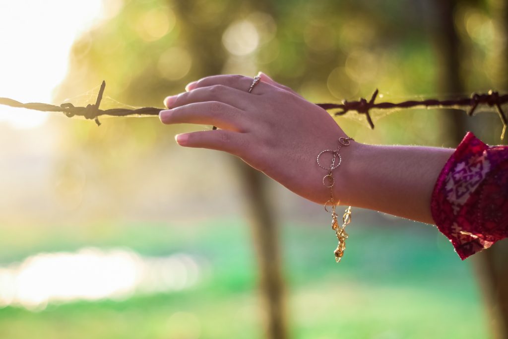 Woman's hand on the fence