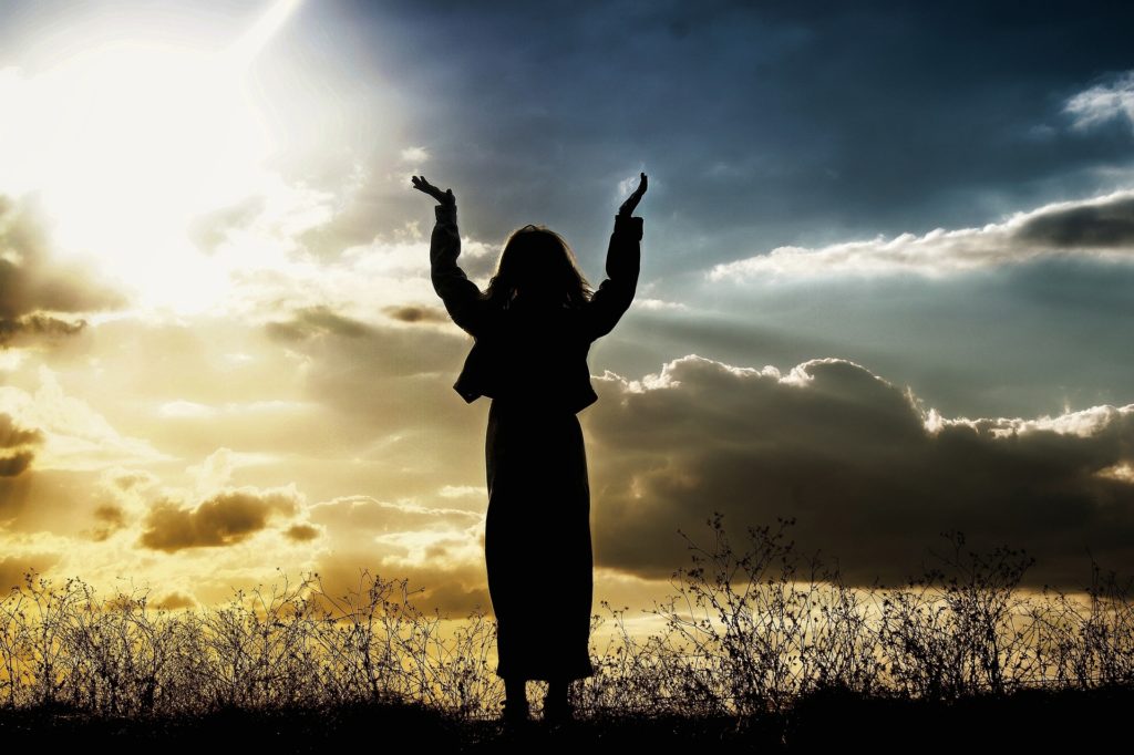 Woman raising hands in faith