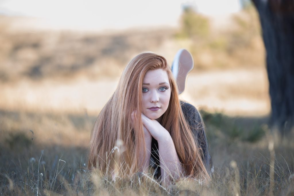 Woman laying in grass, struggling with Disordered Eating