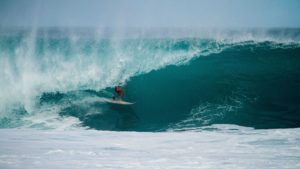 Surfer riding waves