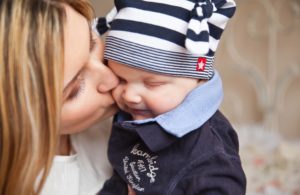 Woman with Postpartum Depression kissing her son