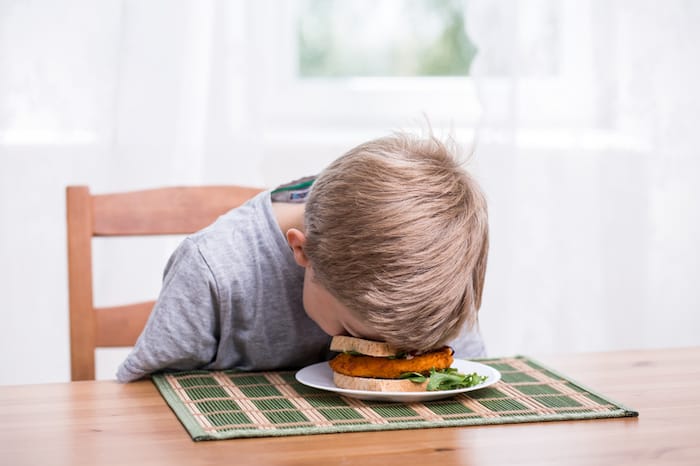 boy with head in food