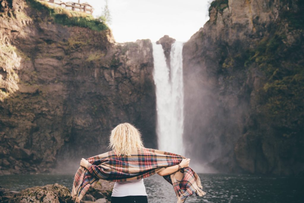 Woman in IOP standing by waterfall