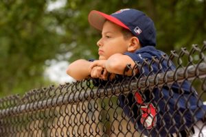 Boy watching in baseball hat