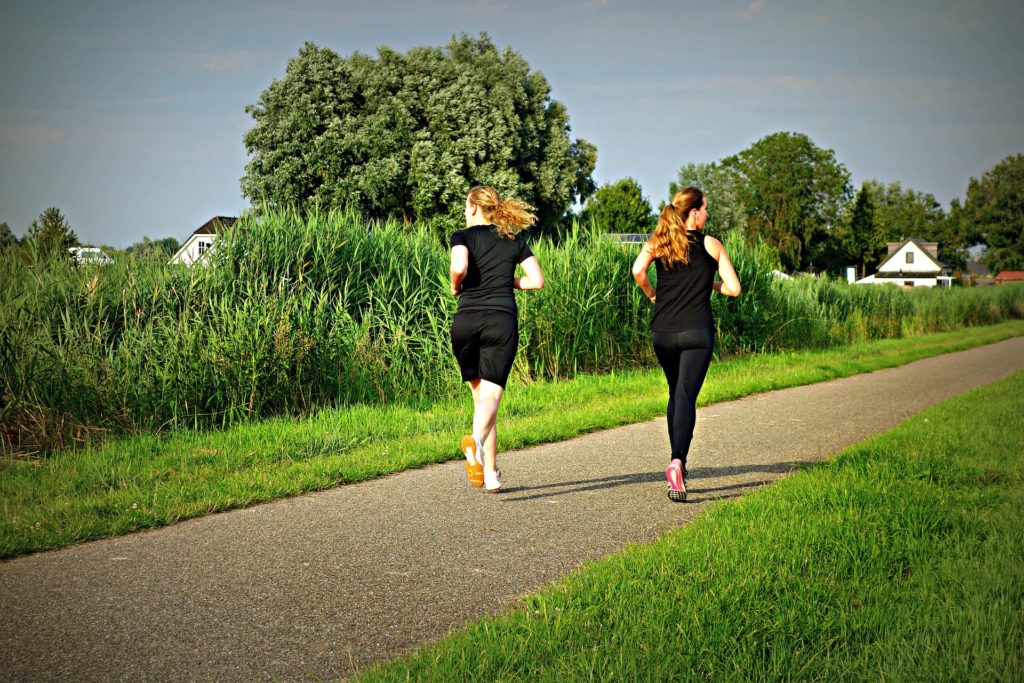 Friends exercise with their fitness trackers