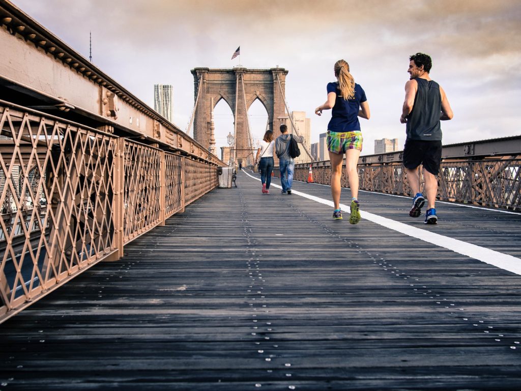 athletes running on the bridge