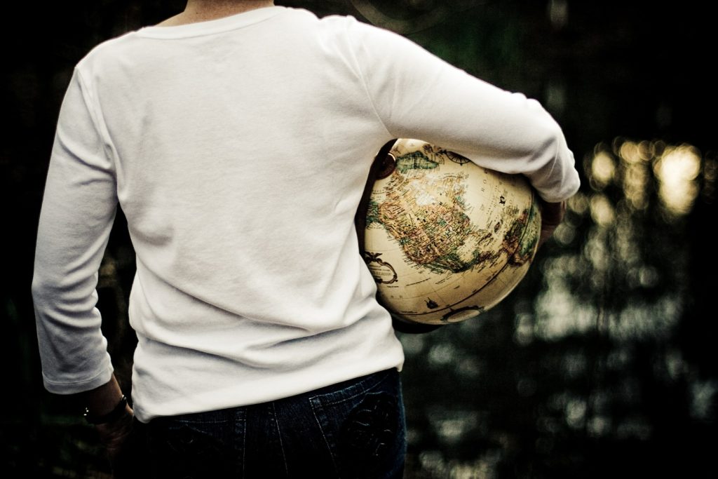 Woman holding world globe while in Eating Disorder Recovery