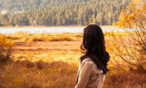 Woman struggling with bulimia looking at lake