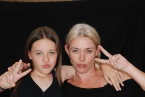 Mother And Daughter Flashing The Peace Sign Durring Family Therapy For Eating Disorders