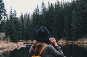 Girl hiking by a river to stay healthy in college