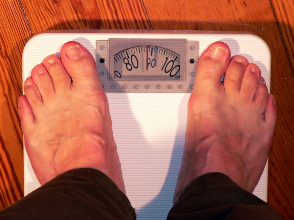 Man weighing in on the scales