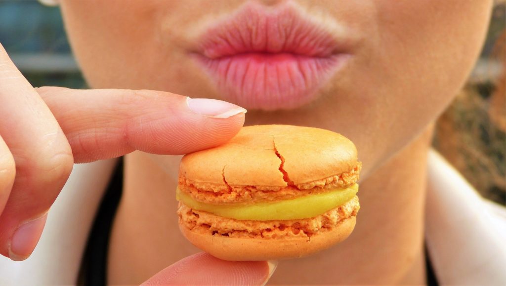 Woman eating a macaroon