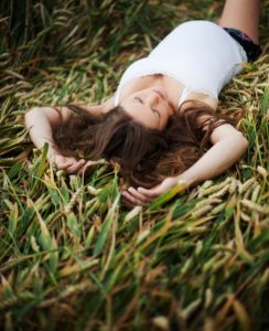 Pregnant woman lying in the grass