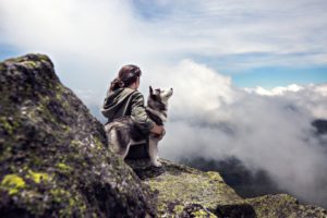 Woman sitting on rock ledge struggling with Body Dysmorphic Disorder