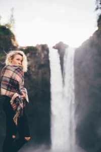 Woman with eating disorder in front of a waterfall