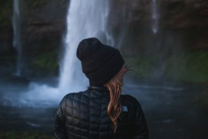 Woman by waterfall