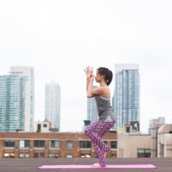 Woman doing yoga on the roof