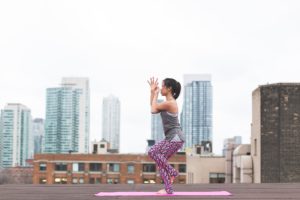 Woman doing yoga on the roof
