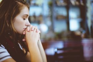 Girl praying for eating disorder recovery