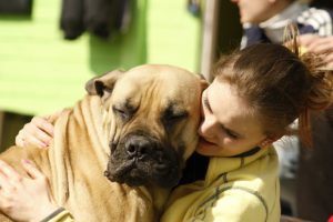 Girl hugging her dog