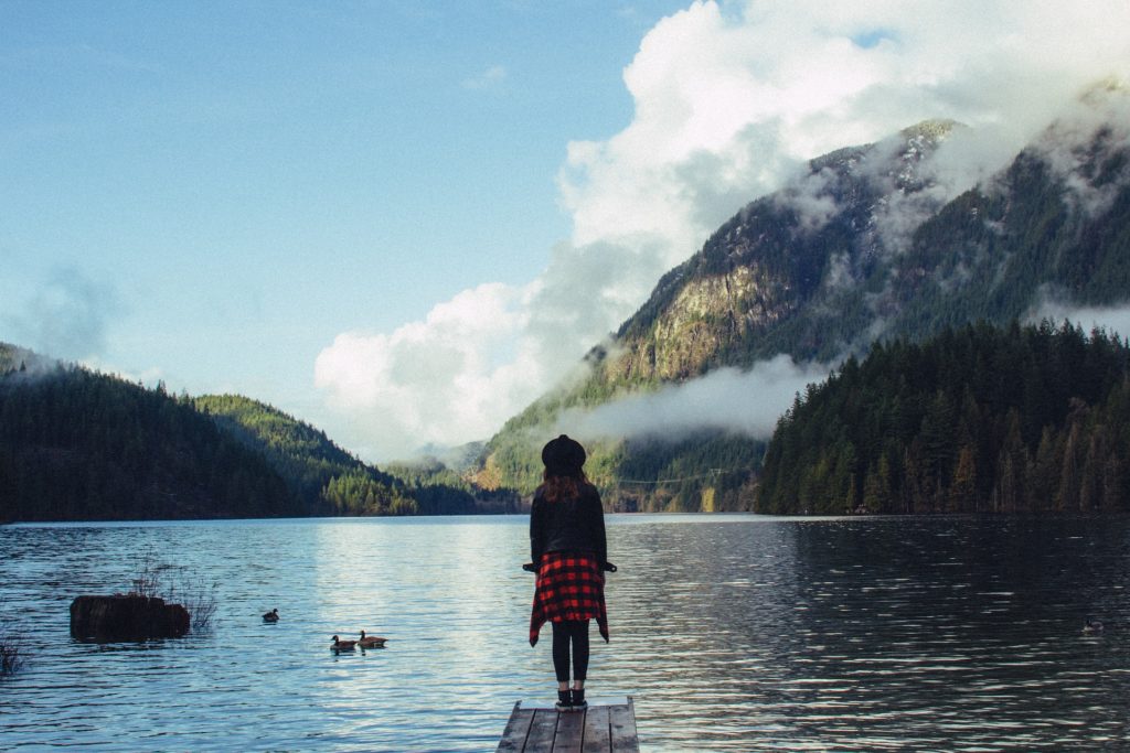 Woman standing by river with Body Dysmorphic Disorder